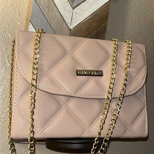 A beige handbag with metal chain strap.
